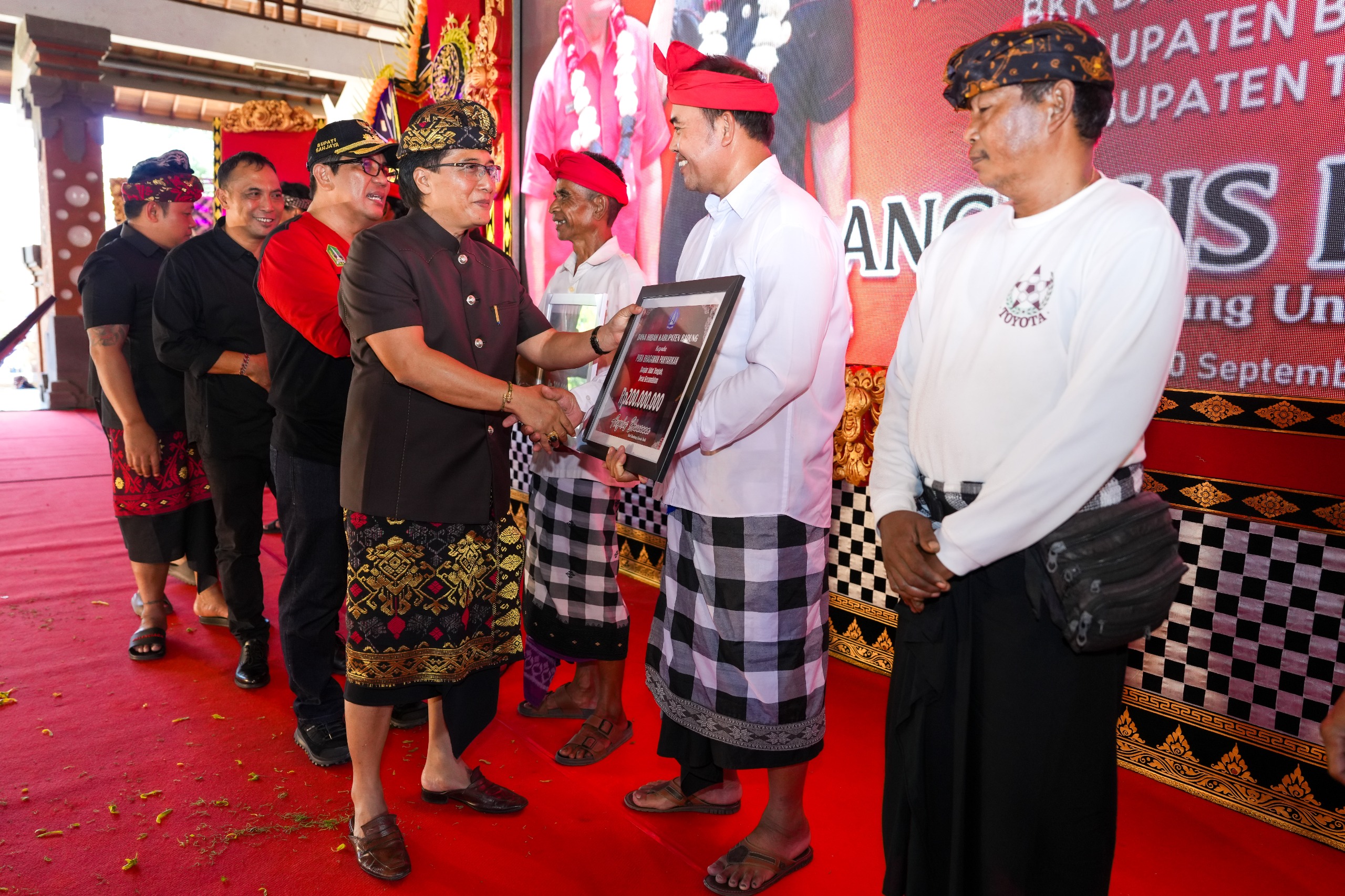 Bupati Nyoman Giri Prasta saat menyerahkan secara simbolis bantuan dana Hibah dan BKK untuk Kabupaten Tabanan, di Gedung Kesenian I Ketut Maria, Delod Peken, Tabanan, Jumat (20/9).